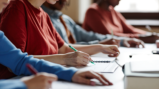 students writing notes in the classroom