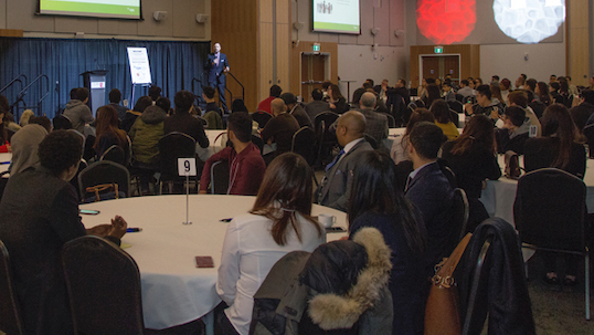 Alumni and students seated at dining tables during speed mentoring event