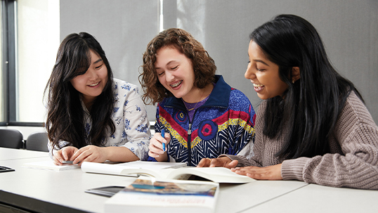 three female students studying book