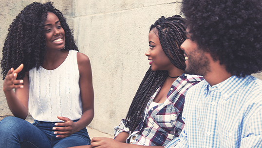 three young black students in conversation