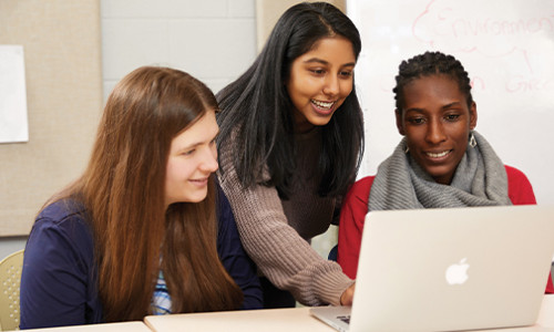 Communication & Media Studies three female students around laptop