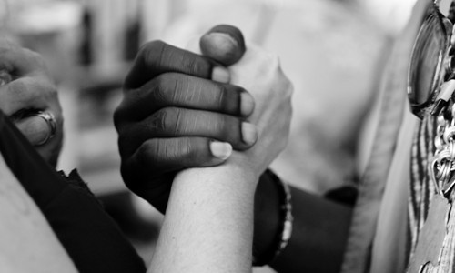Certificate in Anti-Racist Research & Practice close up of white and black persons clasping hands
