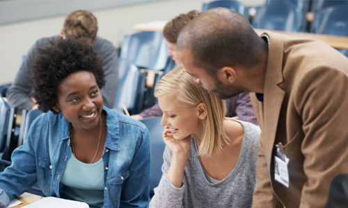 focus on three students studying together at desk