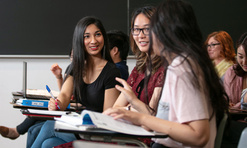 cheerful students interacting in tutorial