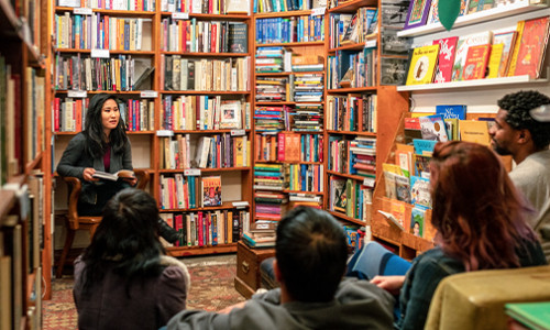 professor reading to students in library