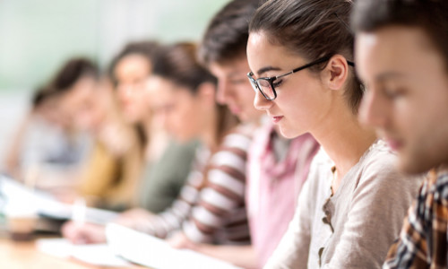 students sitting in a row at their desks