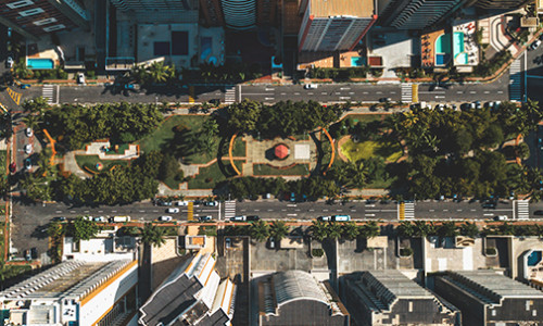 Urban Studies view from tall building onto wide, tree-lined boulevard