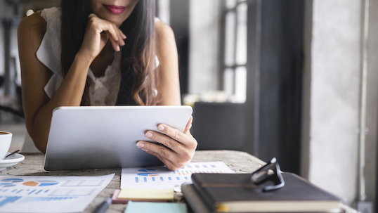 Woman with a tablet in her hand looking at the screen