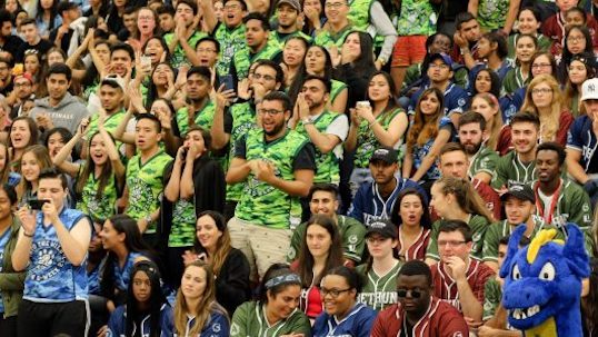 Peer Leader Community Of Practice cheers at a York University sporting event 