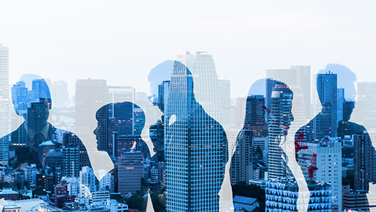 silhouettes of business people with office skyline in background