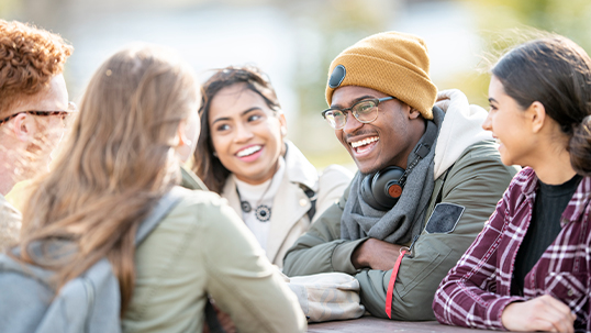 students sitting and chatting at a table