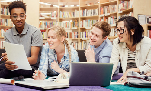 four diverse students in library