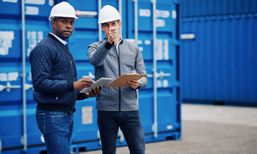 two warehouse staff in conversation