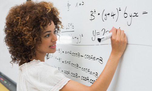 a woman solving math equation on the whiteboard