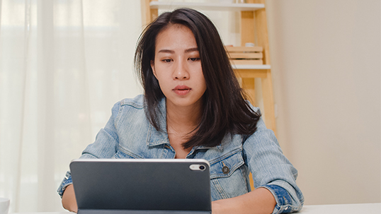 a young woman while working on a tablet