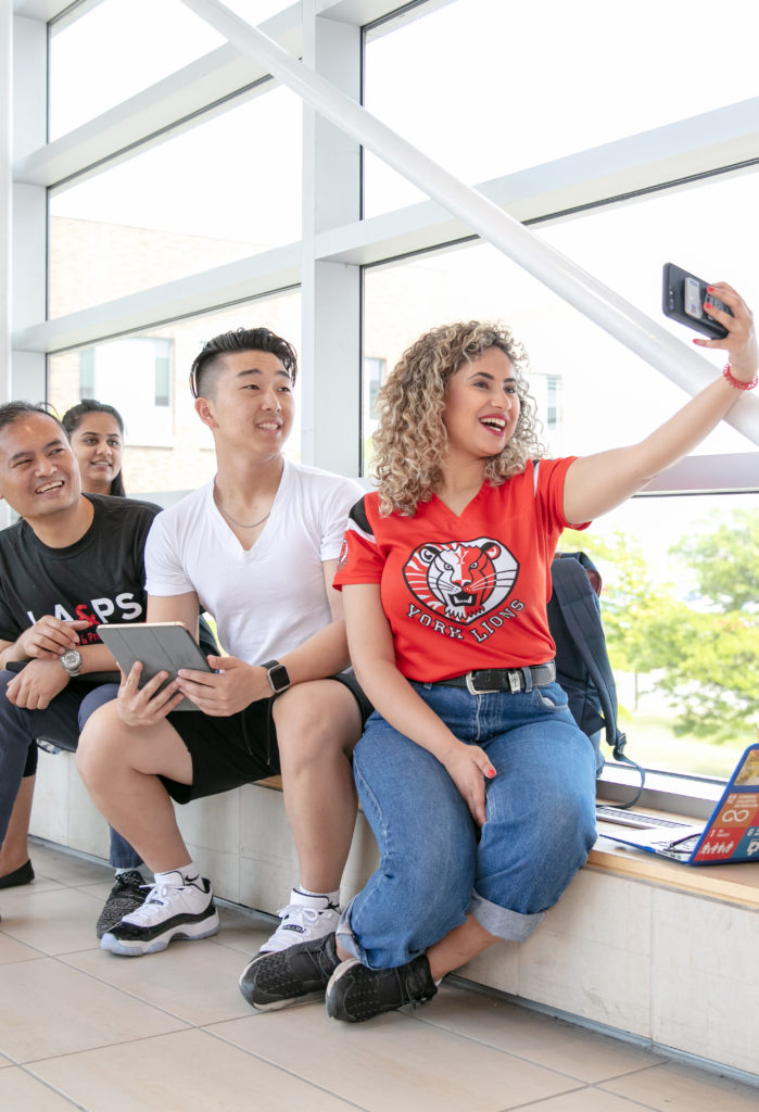 students taking a selfie on campus