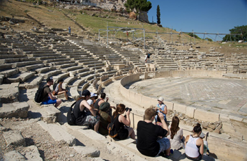 Students sit at an amphitheatre in Greece