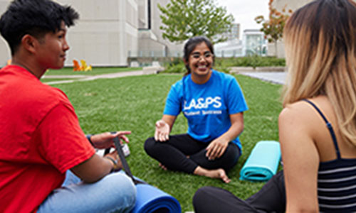 students sitting in the ground