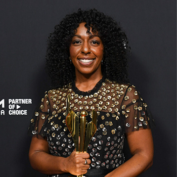 Marsha Green holding trophies at the awards show