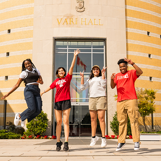 students jumping in front of vari hall