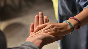 a person holding another individuals hand in their palm