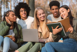 Happy student studying outside