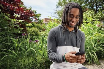 black student checking his phone