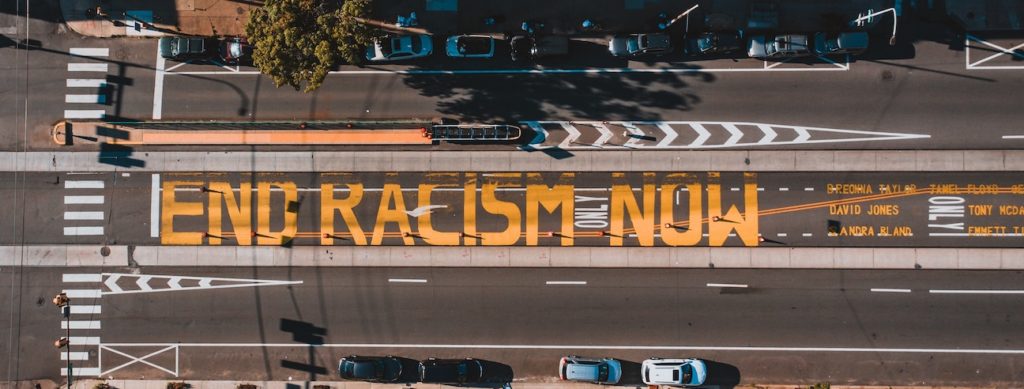 Road with "End Racism Now" painted in yellow