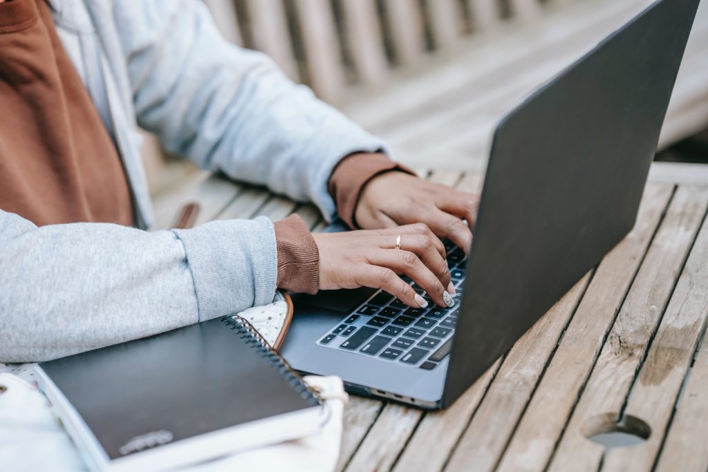 hands typing on laptop