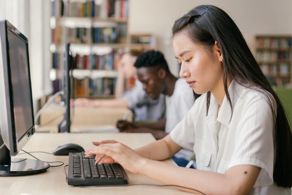 Girl sitting at public computer