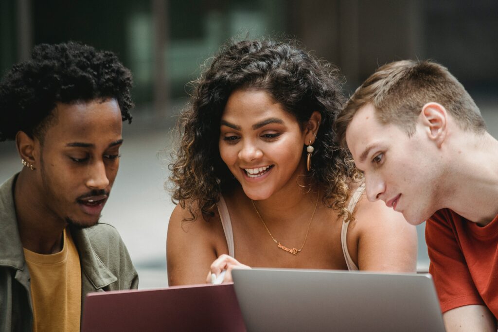 Three people staring at their laptops