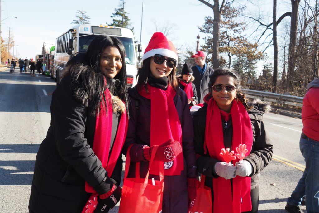 students walking in red scarves at a parade