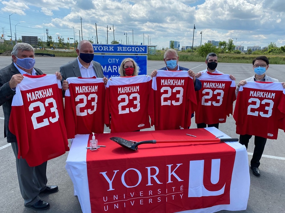 six people holding up markham hockey shirts