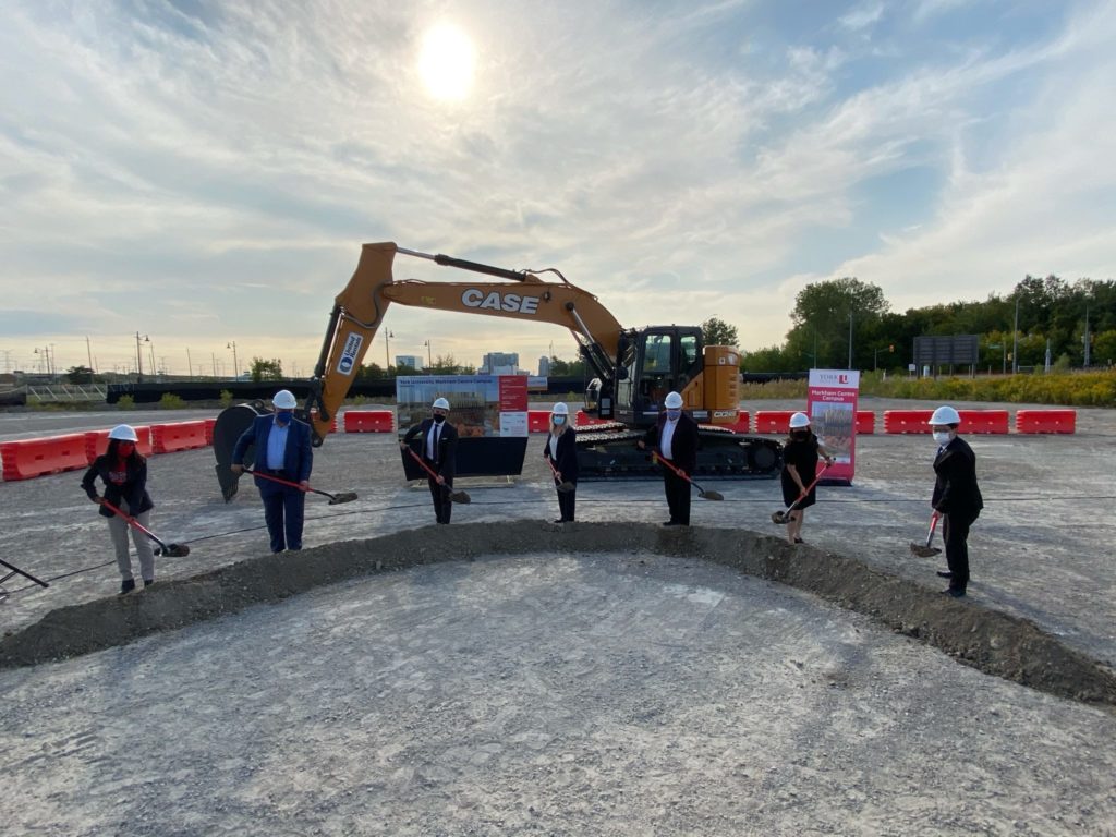 In September 2020, University community members joined representatives from local, regional and provincial governments for an official ground-breaking ceremony at the site for the new campus. The image shows people with shovels turning dirt in a ceremony.