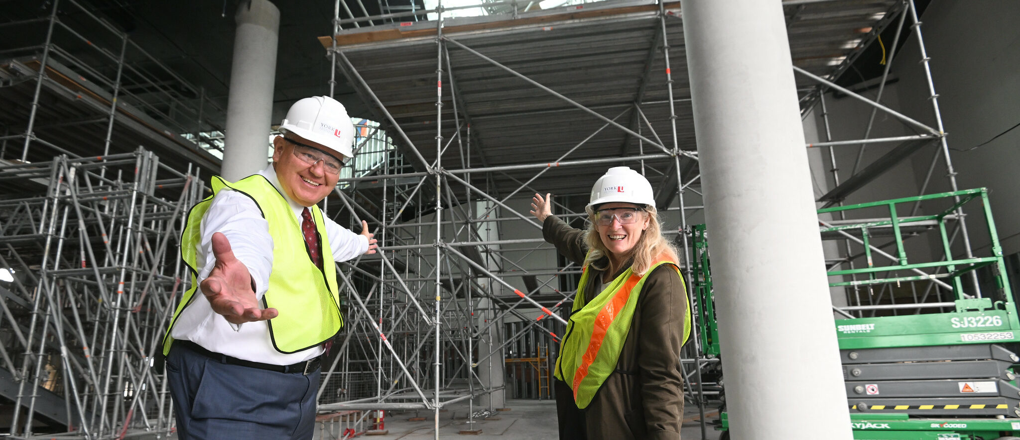 Photo of President and Vice-Chancellor Rhonda Lenton and Markham Mayor Frank Scarpitti standing in front of building construction
