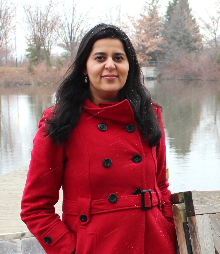 Sapna Sharma in front of a lake