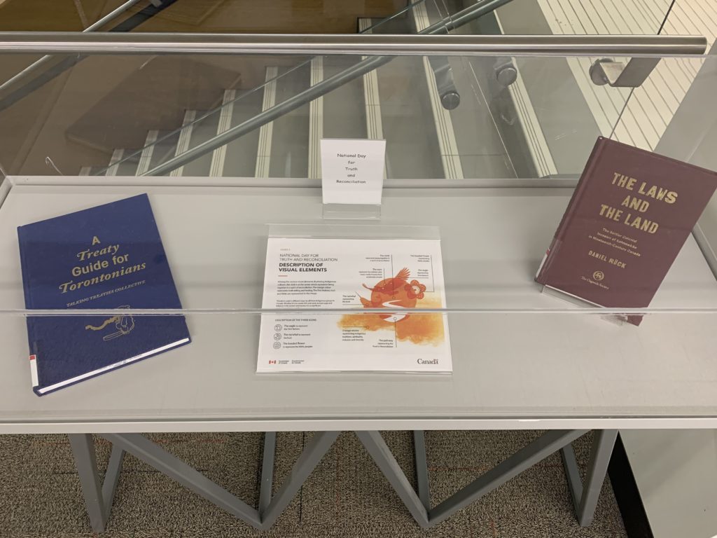 Books from Truth and Reconciliation display, including A Treaty Guide for Torontonians, The Laws and The Land, and a description of visual elements