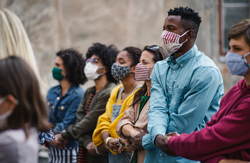 Different people sitting with mask.