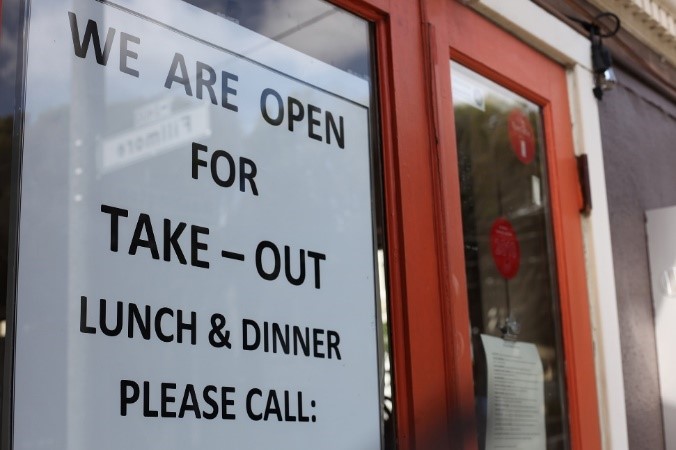 A sign on the door of restaurant.