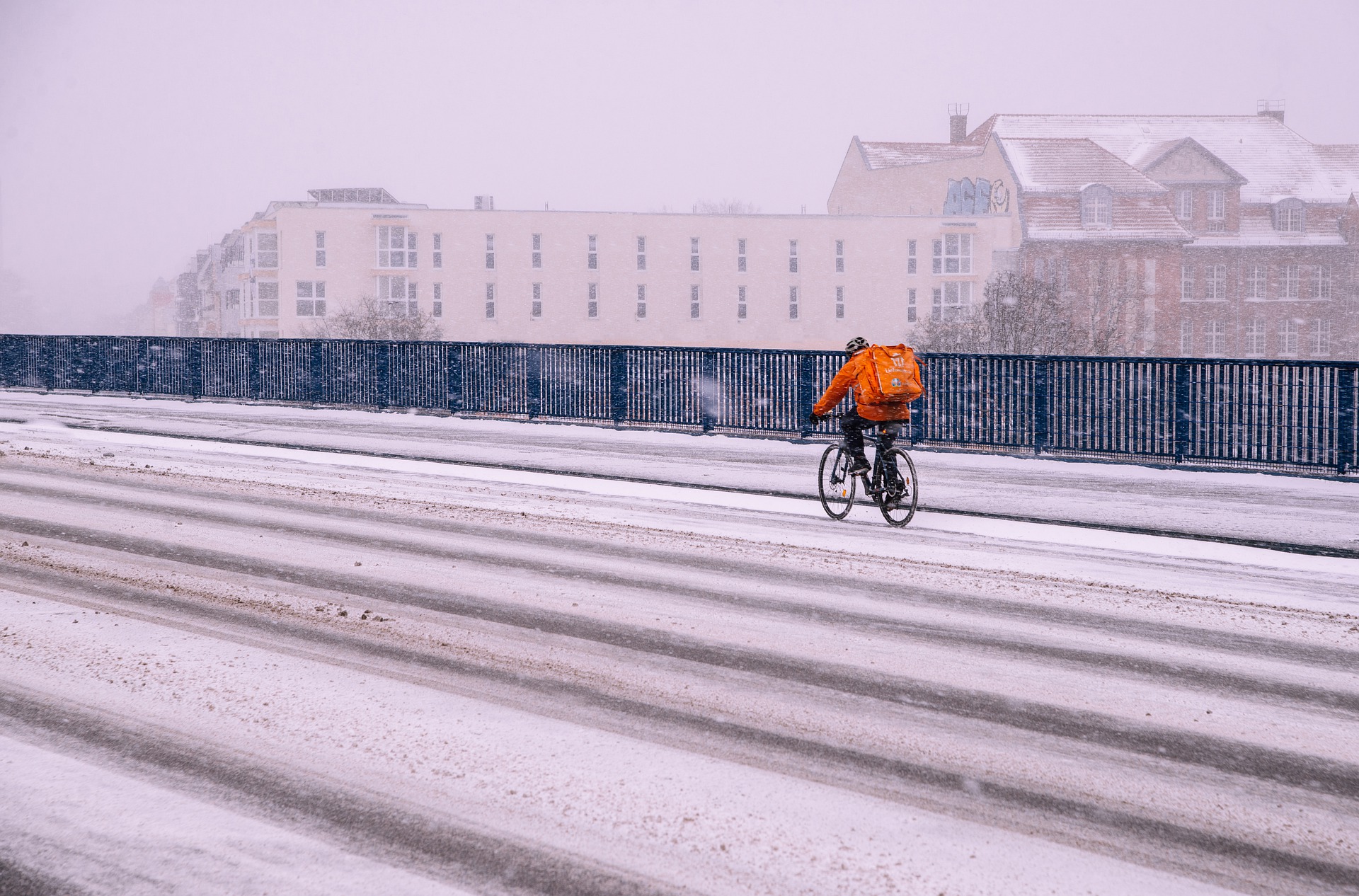 Gig worker cycling in the snow