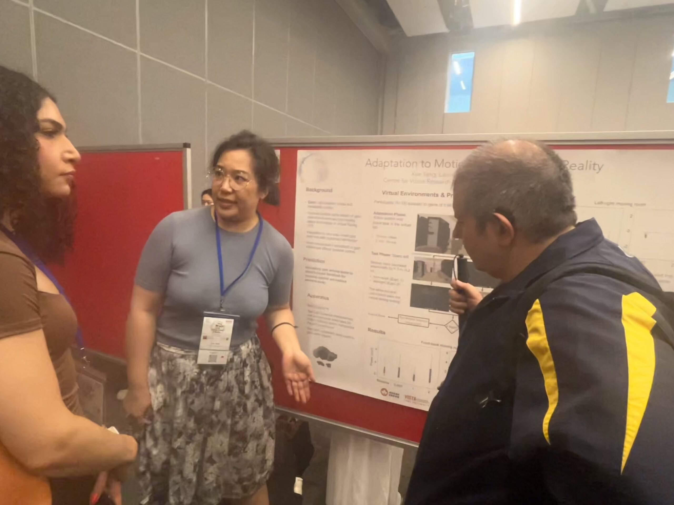Xue standign in front of her poster on motion gain adaptation in Virtual Reality.