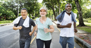 Three middle-aged adults running. 