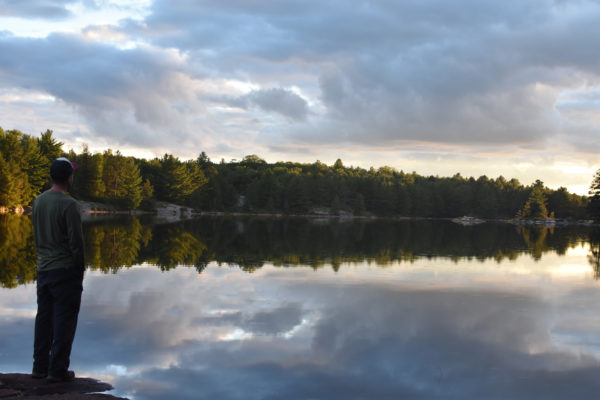 Postdoctoral Fellow Alessandro Filazzola standing at the edge of David Lake in Killarney Provincial Park. Photo by Amanda Liczner