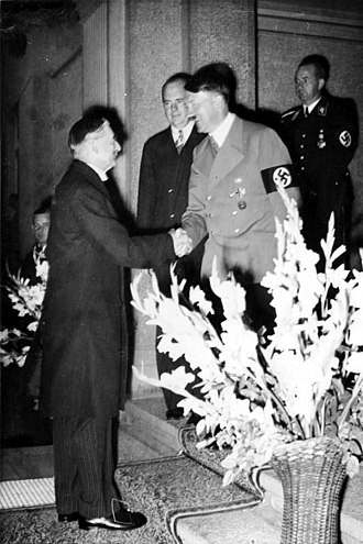 Neville Chamberlain greets Hitler in 1938