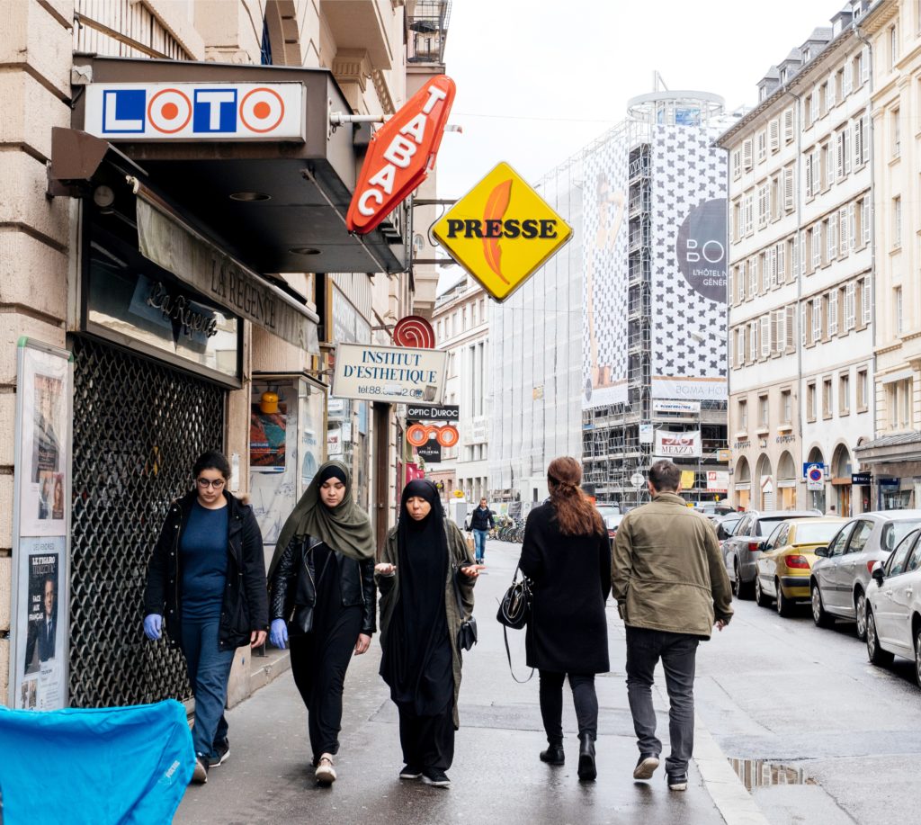 French republican secularism demands that newcomers shed their cultural and religious particularities. Here, two Muslim women in France retain their religious attire: the hijab and shayla