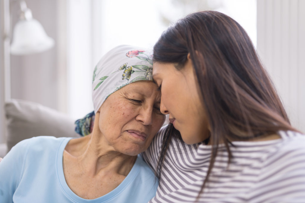 Woman comforting cancer patient