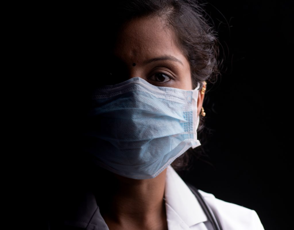 Image of masked healthcare worker, female