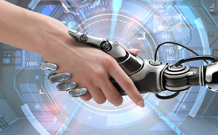 A human hand and robot hand shake hands