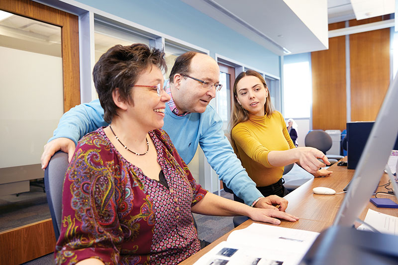 A professor with research students.