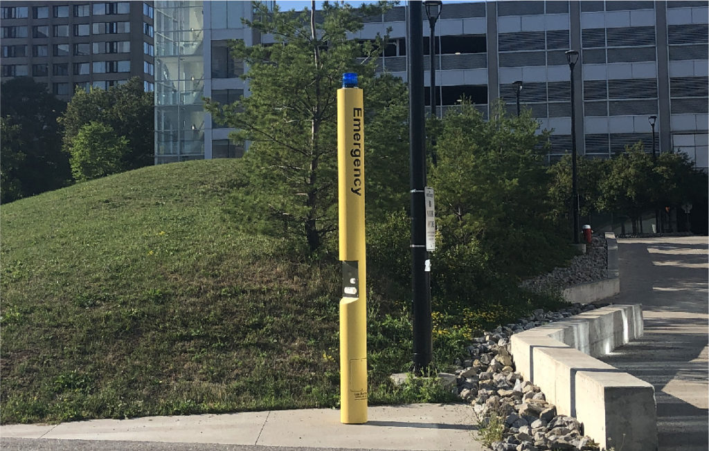 Blue light emergency phone located on a walkway